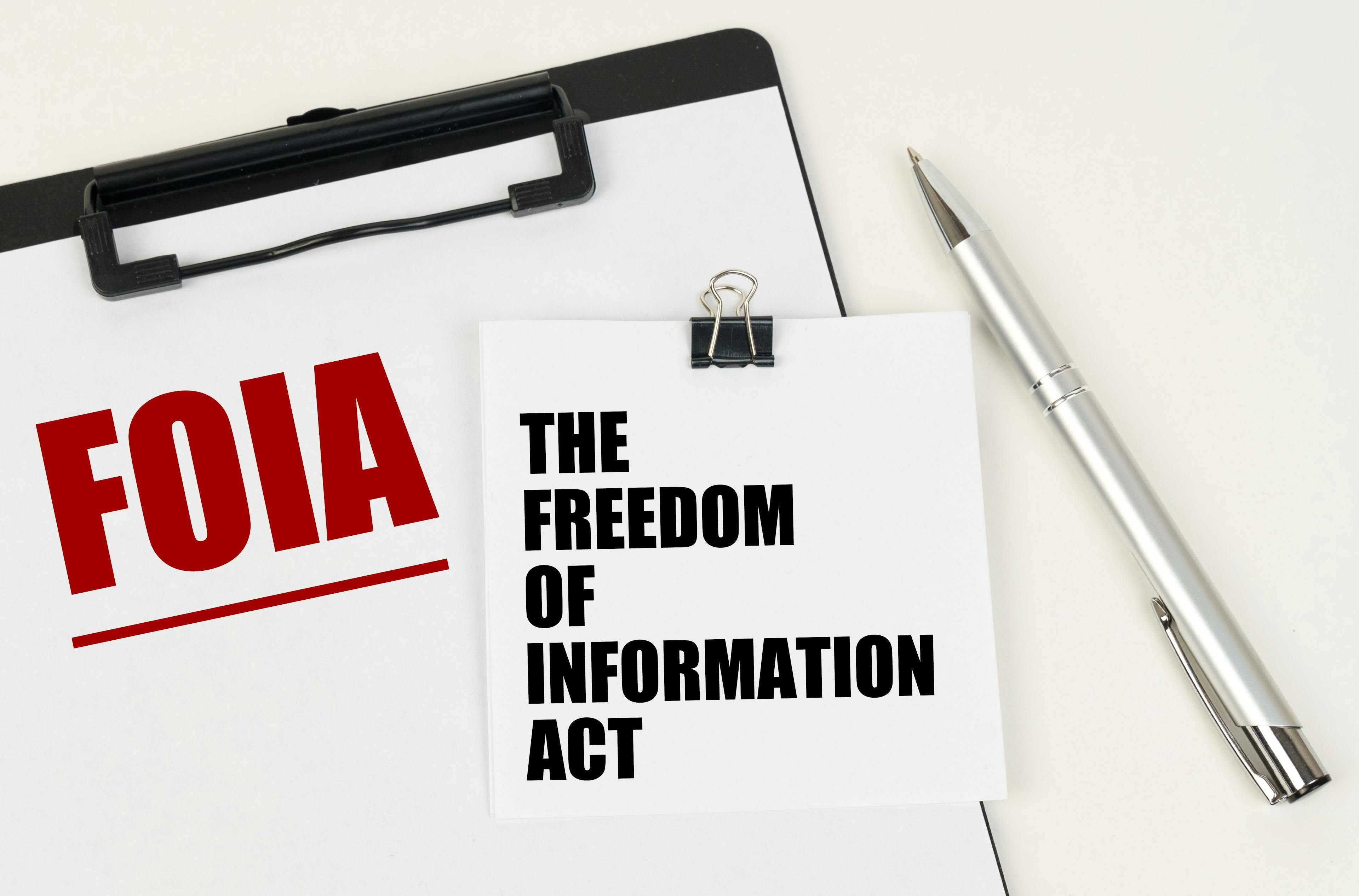 On the tablet, a sheet of paper and stickers with the inscription - FOIA, THE FREEDOM OF INFORMATION ACT |  Dzmitry - stock.adobe.com